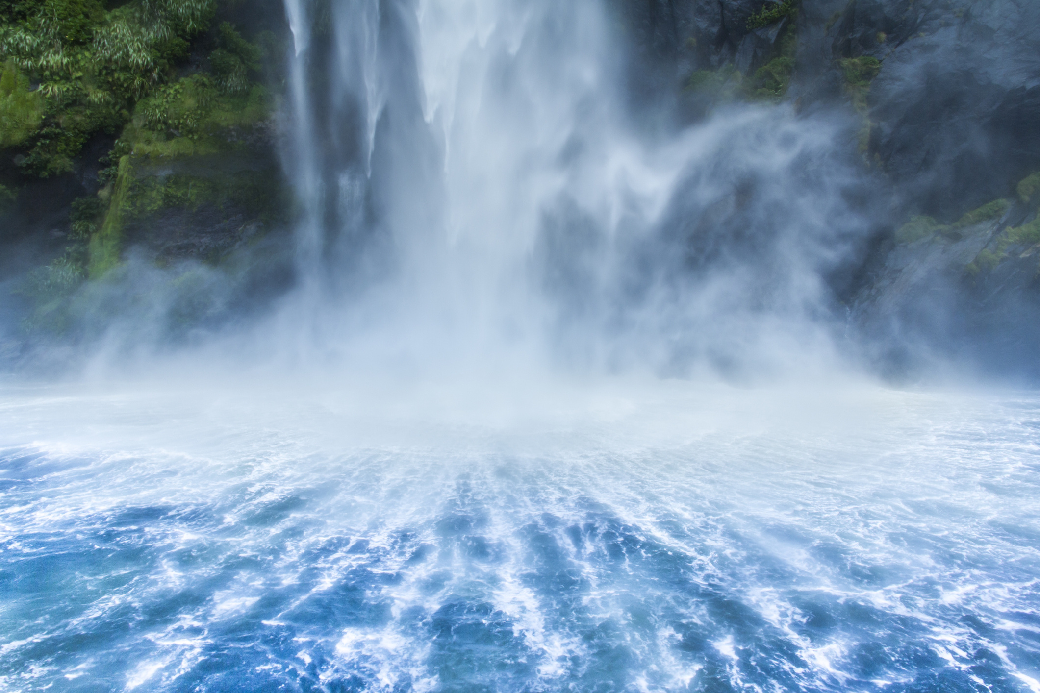 Milford Sound is one of New Zealand's natural wonders; the fresh waterfall creates symmetrical patterns in fjord water and is a popular tourist destination.