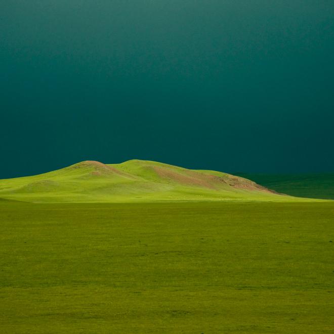 Sunlight on grasslands in the Tibetan Plateau at an elevation of over 13,000 feet.