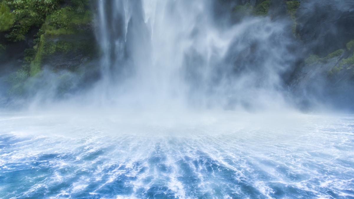 Milford Sound is one of New Zealand's natural wonders; the fresh waterfall creates symmetrical patterns in fjord water and is a popular tourist destination.