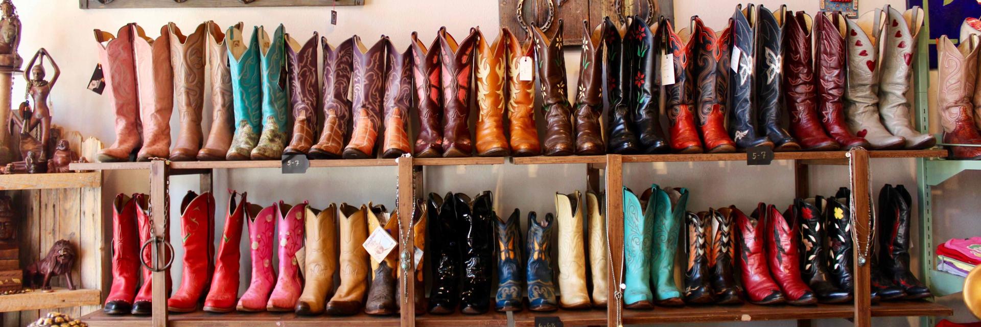A display of vintage and secondhand boots from My Flaming Heart, a handmade and vintage boutique store in Houston Texas, USA.