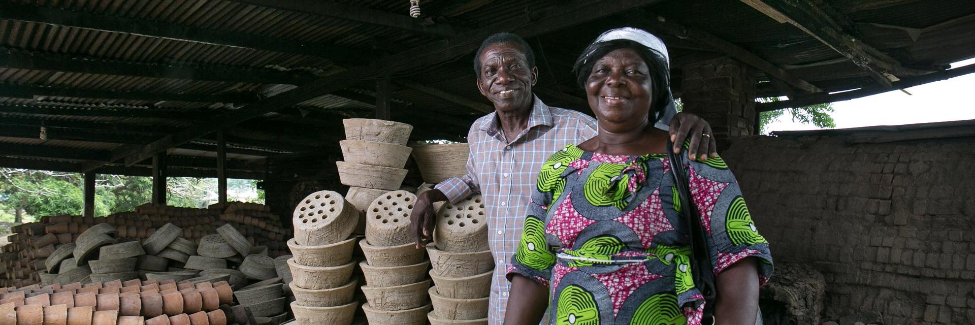 Richard and Gladys Eken standing beside ceramic liners that they make for clean cookstoves.