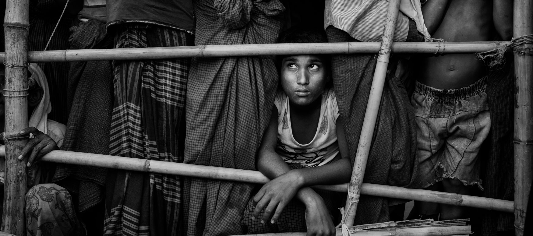 Black and white image of a young child looking up and away from the camera