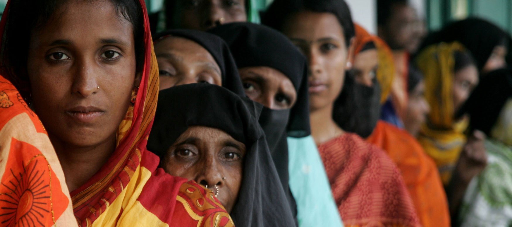 Bangladeshi villagers queue to have their photographs and signatures taken and saved to an extensive database in Rajashi Division some 200kms north-west of Dhaka on March 16, 2008, as part of a United Nations Development Programme (UNDP) voting initiative.